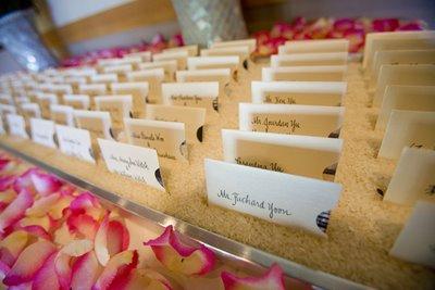 Mrs. Emerald's place cards in a tray of rice