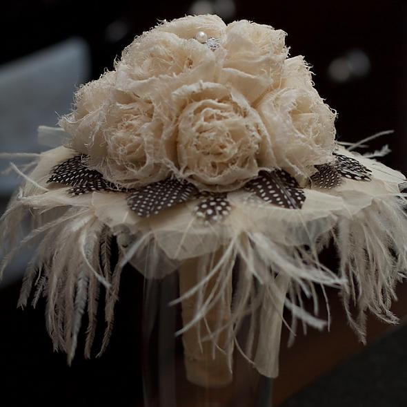 Frayed flower and feather bridal bou