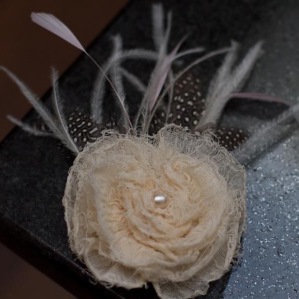 Frayed flower and feather corsage.