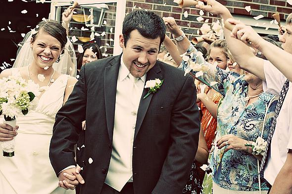 Leaving the ceremony in a shower of rose petals